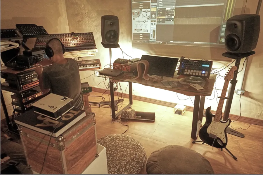 Wide Dosel studio room with instruments, monitors and audio gear