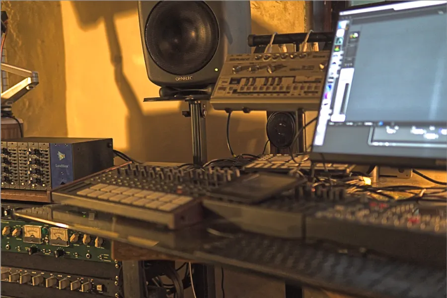 Studio desk with monitors, synthesizers and audio processors